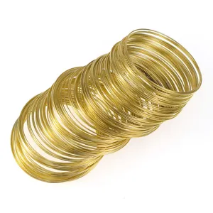 Close-up detail of golden memory wire loops bundle for DIY jewelry craft making accessories.