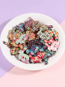 Close-up detail of colorful printed wooden bunny buttons in a white plate, mixed patterns.