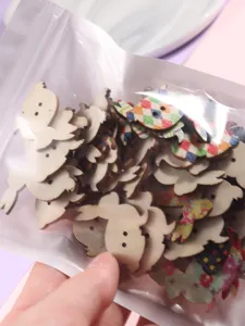 Assorted cartoon rabbit wooden buttons with cute print patterns, perfect for DIY sewing and crafts.