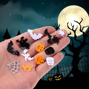 Close-up of assorted Halloween party confetti pieces including bats, ghosts, and skulls.