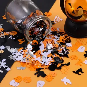 Halloween party confetti sequins detail shot showing mixed spooky shapes like ghosts and bats.