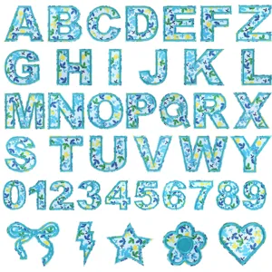 Detailed view of blue floral embroidered alphabet patches, numbers and cute decorative shapes.