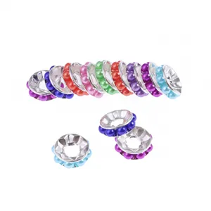 Close-up of colorful ABS plastic wheel spacer beads with pearl inlay for DIY jewelry making.