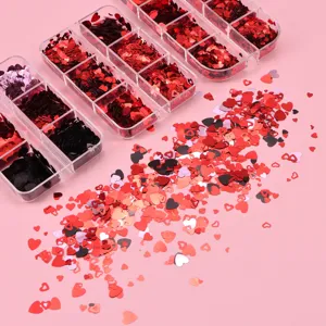 Close up of heart nail art sequins in clear storage boxes and scattered on pink background.