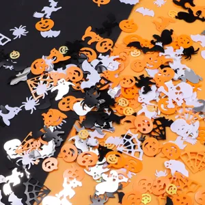 Halloween party confetti detail shot featuring assorted spooky shapes like pumpkins ghosts and bats.