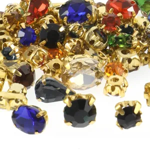 Close-up detail of colorful glass claw rhinestones in metal settings for DIY apparel.