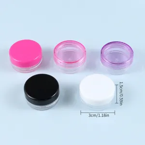 Piccoli barattoli cosmetici trasparenti in plastica con coperchi colorati per creme.
