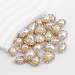 Detail view of pearl rhinestone buttons, heart and teardrop DIY craft clothing accessories.