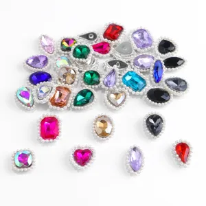 Close-up detail of colorful rhinestone buttons with pearl borders, ideal for apparel decoration.