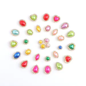 Detail view of colorful rhinestone pearl flatback buttons and DIY craft accessories for decoration.