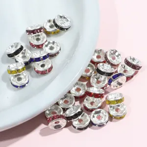 Detail view of colorful rhinestone metal rondelle spacer beads for DIY bracelets and jewelry making.