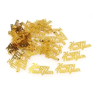 Gold plastic happy new year confetti for party decoration, shiny tabletop glitter pieces.