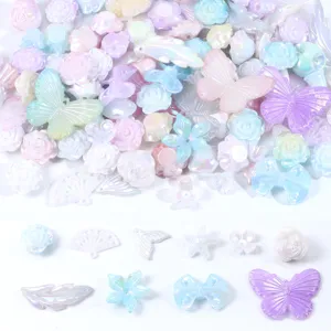 Mixed pastel DIY craft charms close-up, butterfly resin beads for phone case decor.