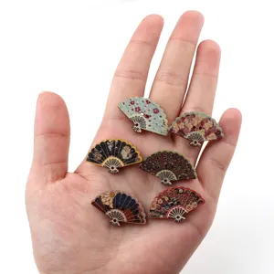 Close-up view of intricate floral painted wooden fan-shaped buttons for DIY crafts detail.