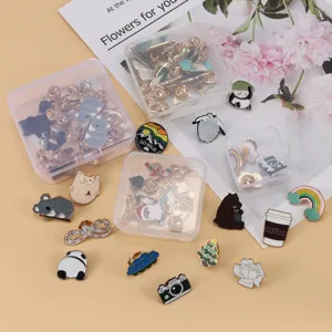 Close-up detail of cute cartoon enamel pins assortment in transparent storage boxes.