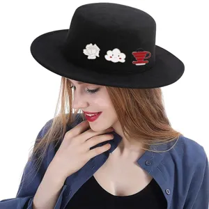 Detail view of cute cartoon brooches decorated on a black hat, stylish accessories for women.
