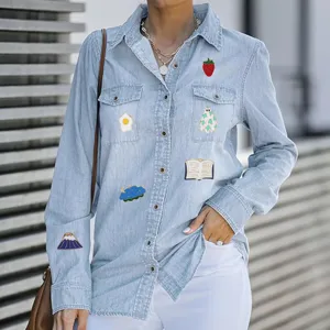 Cute cartoon enamel lapel pin badge set showcased on casual light blue denim shirt detail view.