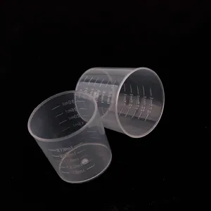 Clear plastic measuring cups detail with visible scale marks for precise DIY crafting work.