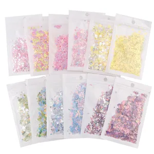 Paillettes per nail art miste colorate stelle cuori conchiglie in 12 bustine trasparenti.