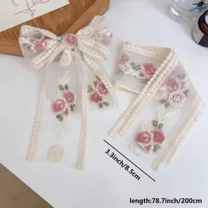 Floral lace ribbon trim with pink embroidery, perfect for DIY crafts and gift packaging.