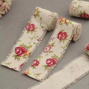 Vintage frayed linen ribbon with red rose floral print for gift wrapping, floral bouquets and DIY crafts