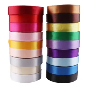 Detailed view of colorful satin ribbon rolls, 20mm wide, perfect for gift wrapping crafts.