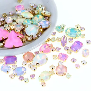 Colored hand-sewn claw rhinestones set in gold metal for DIY clothing and jewelry crafting.