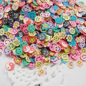 Macro detail of mixed 5mm polymer clay slices with colorful smiley faces and floral patterns.