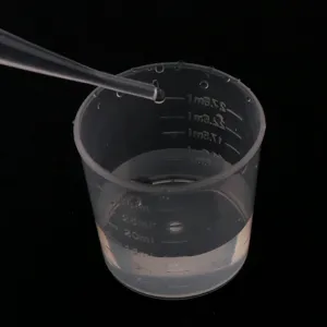 Plastic graduated measuring cup with dropper for DIY epoxy resin craft making details view
