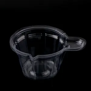 Detail shot of the transparent plastic measuring cup with a spout for DIY epoxy resin crafts.