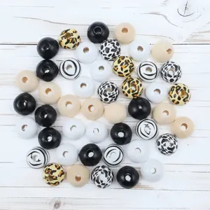 Assorted wooden beads with leopard, cow, and swirl prints for DIY jewelry making.