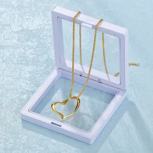 Gold open heart pendant necklace elegantly displayed inside a transparent floating display box.