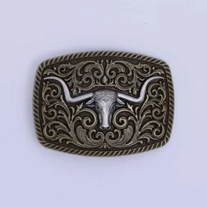 Vintage metal belt buckle detail, western longhorn bull head embossed design accessory.