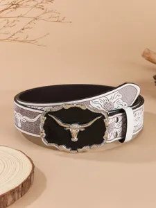Detailed close-up of vintage western cowboy belt with embossed floral and bull buckle.