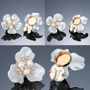 Detailed view of white flower pearl rhinestone cufflinks showing front design and back clasp.