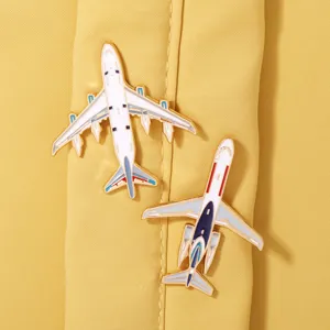 Detail shot of creative metal airplane enamel pins, ideal backpack accessory and military fan gift.
