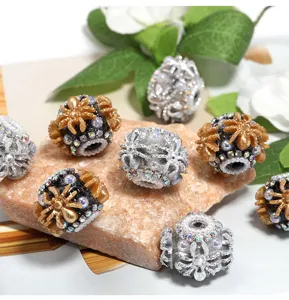 Close-up detail of ornate DIY rhinestone acrylic beads with spider design for accessories.