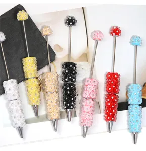 Colorful DIY beaded ballpoint pens with clay flowers and rhinestones, cute macaron colors.