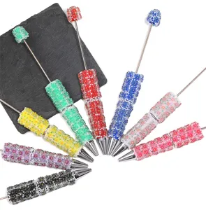 Detailed view of colorful resin floral beaded DIY pens with sparkling diamond flowers and stick.
