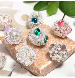 Close-up detail of ornate pearl rhinestone beaded spheres, perfect for DIY jewelry accessories.