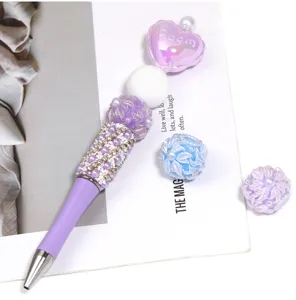 DIY beaded ballpoint pen set with purple acrylic flower beads and sparkling rhinestones.