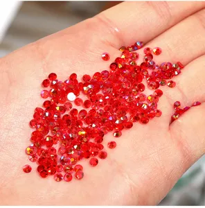 Close-up detail shot of vibrant red resin flatback micro rhinestones for nail art and DIY crafts.