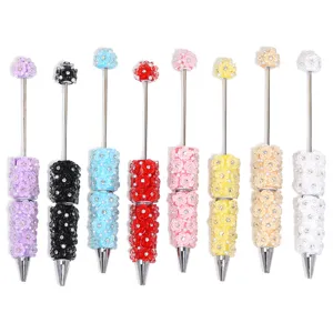 Colorful DIY beaded pen set with cute clay flower and rhinestone decor for writing and crafting.