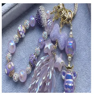 Purple DIY beaded keychain accessory detail with sparkly rhinestones and cute resin pendants.
