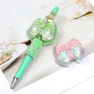 Stylo de perles DIY avec nœud pailleté dégradé et accessoire nœud scintillant pour loisirs.