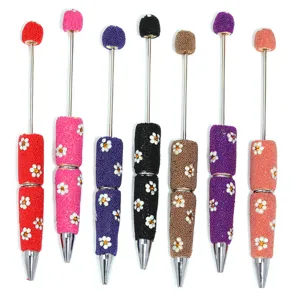 Detailed view of handmade beaded ballpoint pens with cute daisy flowers and vibrant seed beads.