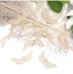 Resin angel wings DIY charms, glitter heart beads for phone chains and jewelry making details.
