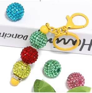 Detailed shot of colorful 20mm rhinestone paved acrylic disco balls and keychain accessories.