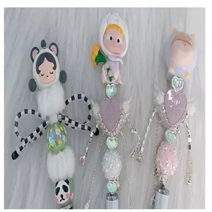 Handmade DIY beaded pen charms with cute cartoon doll heads and shiny rhinestone hearts.