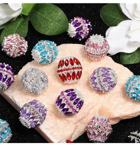 Close-up detail of colorful rhinestone hollow alloy beads for DIY jewelry making and phone charms.